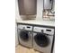 Bright laundry room featuring washer and dryer, counter space and storage at 4510 El Conquistador Pkwy # 105, Bradenton, FL 34210