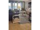 A well-lit living room with neutral tones and a blue area rug, stylish furniture, and bright pops of color at 4510 El Conquistador Pkwy # 105, Bradenton, FL 34210