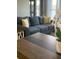 Close up of a modern living room featuring a stylish blue couch and tasteful decor at 4510 El Conquistador Pkwy # 105, Bradenton, FL 34210