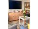 A living room displaying bright flowers, side table with a lamp, and a modern cabinet with decor at 4510 El Conquistador Pkwy # 105, Bradenton, FL 34210