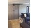 Comfortable living room featuring a barn door, cozy seating, and stylish decor at 4510 El Conquistador Pkwy # 105, Bradenton, FL 34210