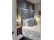 Tastefully decorated main bedroom featuring wood paneling and a plush upholstered headboard at 4510 El Conquistador Pkwy # 105, Bradenton, FL 34210