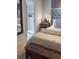 Main bedroom featuring ensuite bathroom access, wood accent wall, and tufted headboard at 4510 El Conquistador Pkwy # 105, Bradenton, FL 34210
