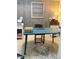 Well-lit home office featuring wood accent wall, large round rug and desk space for efficient work at 4510 El Conquistador Pkwy # 105, Bradenton, FL 34210