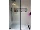Modern shower with glass door, rainfall showerhead, white tile, and patterned accent tiles at 4510 El Conquistador Pkwy # 105, Bradenton, FL 34210