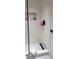 Modern shower with white subway tile, glass door, patterned inset, black fixtures, and built-in niche at 4510 El Conquistador Pkwy # 105, Bradenton, FL 34210