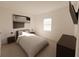 Comfortable bedroom showcasing bedside tables, reading lamps, wall art and warm carpet at 4610 Hawthorn Avenue, Parrish, FL 34219