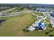 Aerial view of a community park and playground surrounded by lush greenery and manicured lawns at 4610 Hawthorn Avenue, Parrish, FL 34219