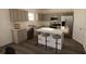 Modern kitchen with stainless steel appliances, gray cabinets, and a center island with seating at 4610 Hawthorn Avenue, Parrish, FL 34219