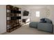 Cozy living room with blue sectional couch, wooden shelving unit, and modern decor at 4610 Hawthorn Avenue, Parrish, FL 34219