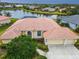 Beautiful aerial view of home with a terracotta roof, lush backyard, and scenic lake views at 4613 Sweetmeadow Cir, Sarasota, FL 34238