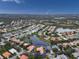 An amazing aerial view shows the property nestled within a lush community with serene lakes and mature trees at 4613 Sweetmeadow Cir, Sarasota, FL 34238