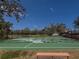 The basketball court is ready for play with a bench for relaxing during or after the game at 4613 Sweetmeadow Cir, Sarasota, FL 34238