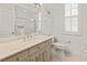Bright bathroom with single vanity, white cabinets, and shower-tub combo and plantation shutters at 4613 Sweetmeadow Cir, Sarasota, FL 34238