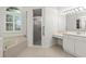 Bright bathroom featuring a bathtub, shower, and vanity with great lighting at 4613 Sweetmeadow Cir, Sarasota, FL 34238