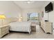 This bedroom is bright and airy and features views of the pool and neutral tones at 4613 Sweetmeadow Cir, Sarasota, FL 34238