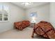 Bright bedroom with neutral walls, tile flooring, twin beds and plantation shutters at 4613 Sweetmeadow Cir, Sarasota, FL 34238