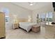 This bedroom is bright and airy and features plantation shutters and neutral tones at 4613 Sweetmeadow Cir, Sarasota, FL 34238