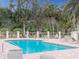 Relax and unwind at the community pool, surrounded by lush landscaping and comfortable seating at 4613 Sweetmeadow Cir, Sarasota, FL 34238