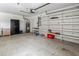 Spacious two car garage featuring overhead lighting, ample storage space and epoxy flooring at 4613 Sweetmeadow Cir, Sarasota, FL 34238