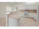 Bright kitchen featuring white cabinets, modern appliances, and light countertops at 4613 Sweetmeadow Cir, Sarasota, FL 34238