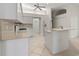 Spacious kitchen with a bar area and modern appliances, including a white refrigerator and range at 4613 Sweetmeadow Cir, Sarasota, FL 34238