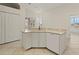 Kitchen sink and counter area featuring sleek cabinets and modern dishwasher at 4613 Sweetmeadow Cir, Sarasota, FL 34238