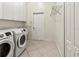 Bright laundry room with modern washer and dryer and ample storage at 4613 Sweetmeadow Cir, Sarasota, FL 34238