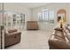 Living room featuring large windows with natural light and comfortable seating at 4613 Sweetmeadow Cir, Sarasota, FL 34238