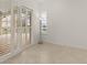 Bright room with tile flooring, louvred doors to the pool, and a view of the water at 4613 Sweetmeadow Cir, Sarasota, FL 34238