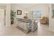 Bright living room featuring tile flooring, comfortable seating, and natural light from large windows and sliding doors at 4613 Sweetmeadow Cir, Sarasota, FL 34238