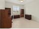 Bright office space with neutral walls, tile flooring, plantation shutters, and built-in shelving for optimal storage at 4613 Sweetmeadow Cir, Sarasota, FL 34238