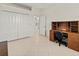 Bright office space with neutral walls, tile flooring, closet space and built-in desk and shelving at 4613 Sweetmeadow Cir, Sarasota, FL 34238