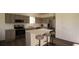 Modern kitchen featuring stainless steel appliances, a large island with seating, and light gray cabinetry at 4614 Hawthorn Avenue, Parrish, FL 34219