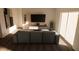 Contemporary living room featuring a comfortable sofa, sleek media console, and bright natural light at 4614 Hawthorn Avenue, Parrish, FL 34219
