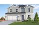 Beautiful home with a two-car garage, green lawn, and colorful landscaping at 4618 Hawthorn Ave, Parrish, FL 34219