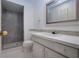 Bright bathroom features tiled floors, a vanity, and walk in shower at 466 Sunnyside Dr, Venice, FL 34293