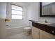Bright bathroom featuring a tiled shower, vanity, and gold hardware at 466 Sunnyside Dr, Venice, FL 34293