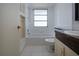 Bright bathroom with white tiled shower, vanity, and built-in shelving at 466 Sunnyside Dr, Venice, FL 34293