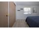 Bedroom with a closet, light wood floors, and natural light from the window at 466 Sunnyside Dr, Venice, FL 34293