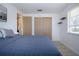Bedroom featuring light wood floors, a closet with doors, and a window at 466 Sunnyside Dr, Venice, FL 34293