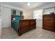 Bedroom boasts a sleigh bed with wood floors, a ceiling fan, and natural light from the window at 466 Sunnyside Dr, Venice, FL 34293