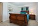 Bedroom featuring a wood sleigh bed, built in shelving, and light wood floors at 466 Sunnyside Dr, Venice, FL 34293