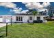 Home featuring a well-manicured lawn and mature trees at 466 Sunnyside Dr, Venice, FL 34293