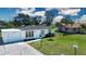 Charming home featuring a well-manicured lawn and mature trees at 466 Sunnyside Dr, Venice, FL 34293