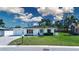 Home featuring a well-manicured lawn and mature trees at 466 Sunnyside Dr, Venice, FL 34293