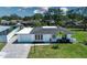 Home featuring a well-manicured lawn and mature trees at 466 Sunnyside Dr, Venice, FL 34293
