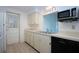 Kitchen features updated cabinets, modern appliances, and bright lighting at 466 Sunnyside Dr, Venice, FL 34293