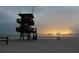 Lifeguard stand on a serene beach at sunrise, offering safety and a scenic view of the ocean at 466 Sunnyside Dr, Venice, FL 34293