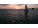 A sailboat at sunset offers a relaxing cruise and adds to the stunning waterfront vistas at 466 Sunnyside Dr, Venice, FL 34293